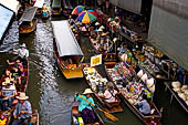 Thailand, Locals sell fruits, food and products at Damnoen Saduak floating market near Bangkok 